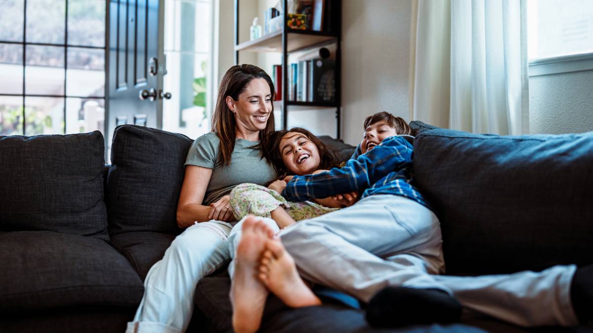 Family smiling on couch